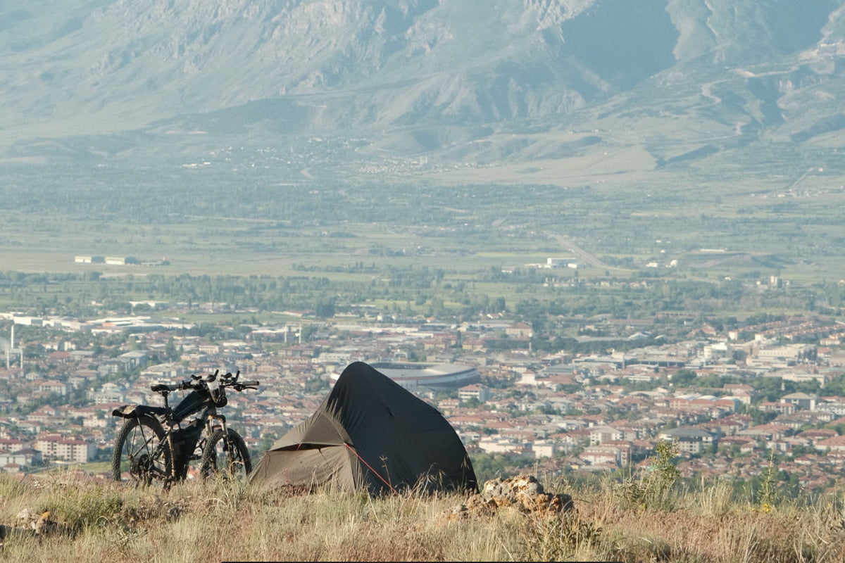 Elliot Silander's tent and loaded touring bicycle pitched on a ridge above the Erzincan valley in Turkey.